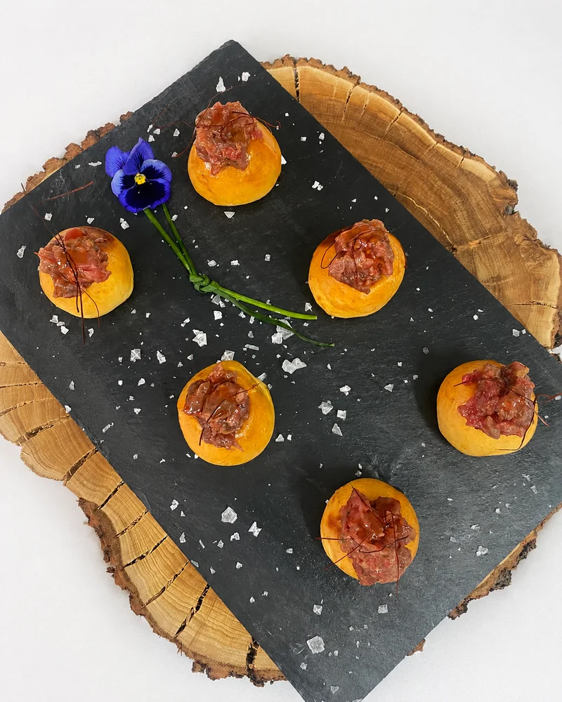 Aperitivos de tartar servidos sobre piedra negra